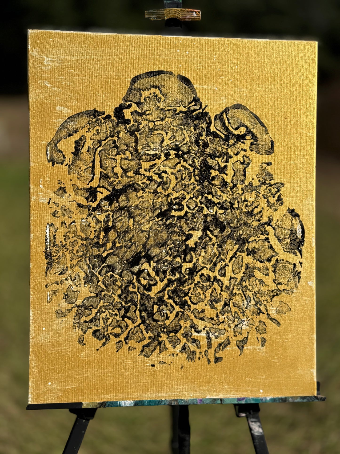 Black foot print on gold canvas
