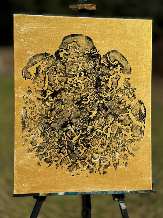 Black foot print on gold canvas